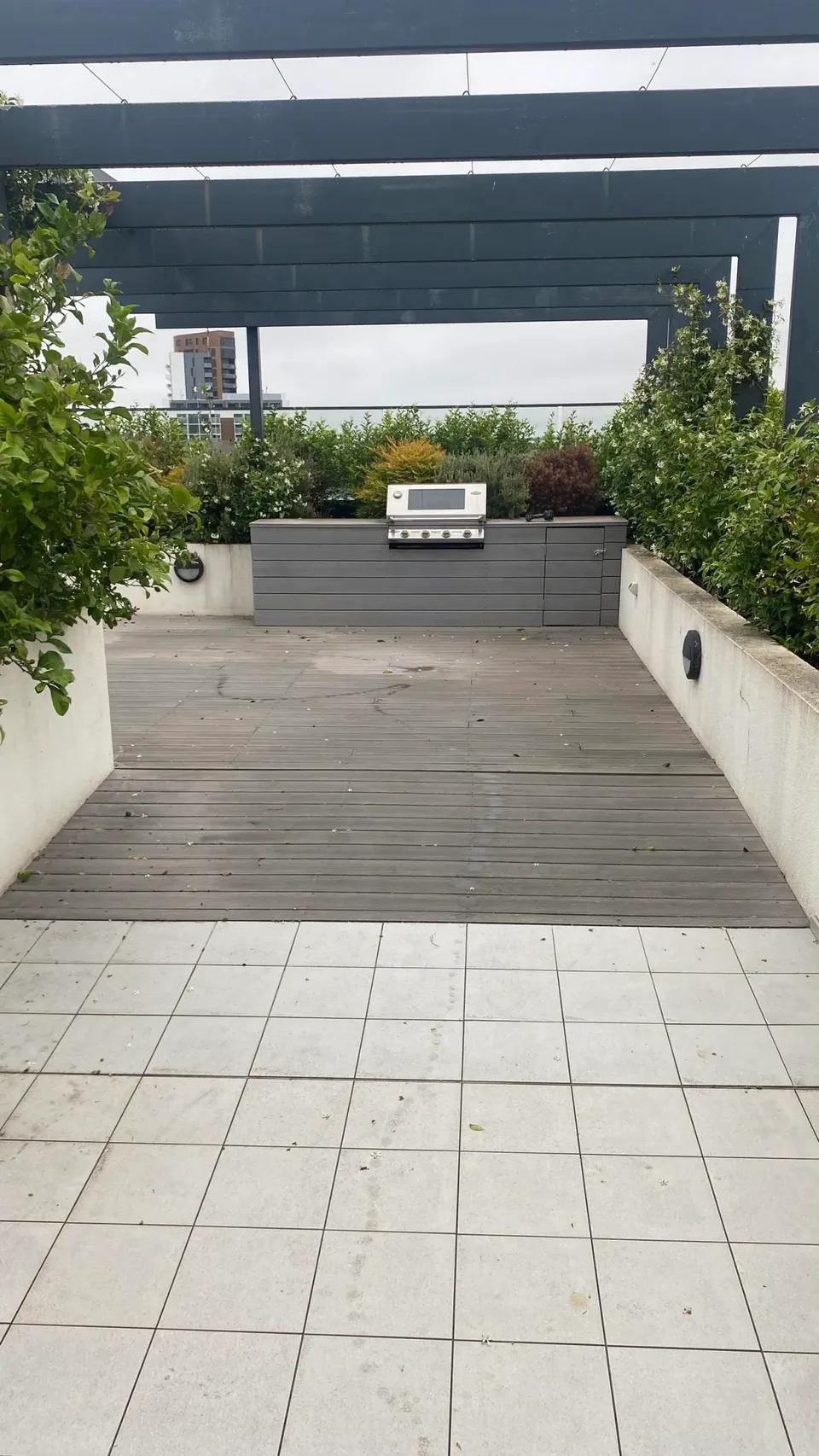 Repaired outdoor courtyard with timber deck and tiled area