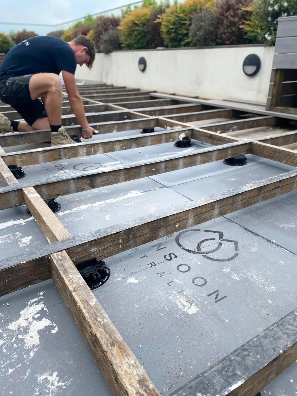 BLR technician rebuilding a balcony waterproofing system
